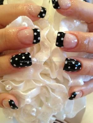 Glossy black polish with white polka dot nail art