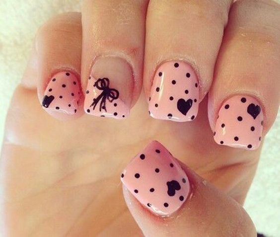 Pleasing and cute nail art with polka dots, hearts and a bow