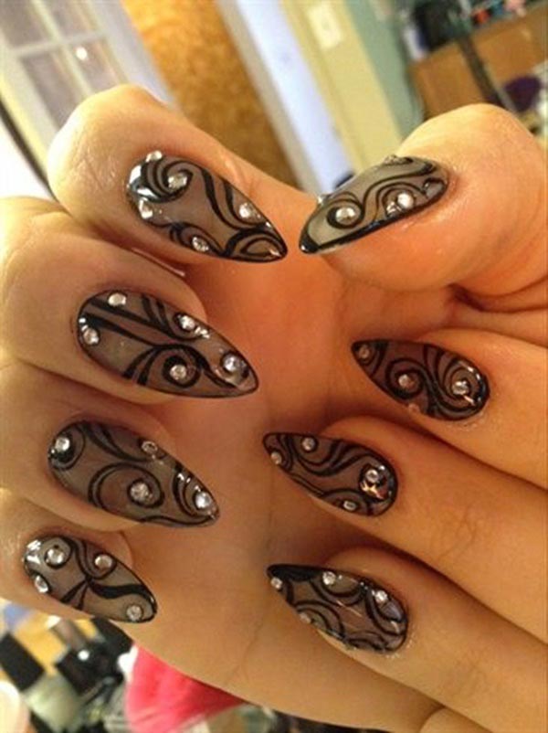Black nail art design with stones