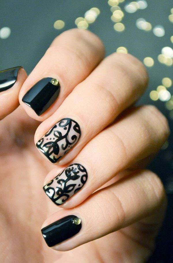 There is no reason to not love such an amazing nail art with stones on black base and lace design on white