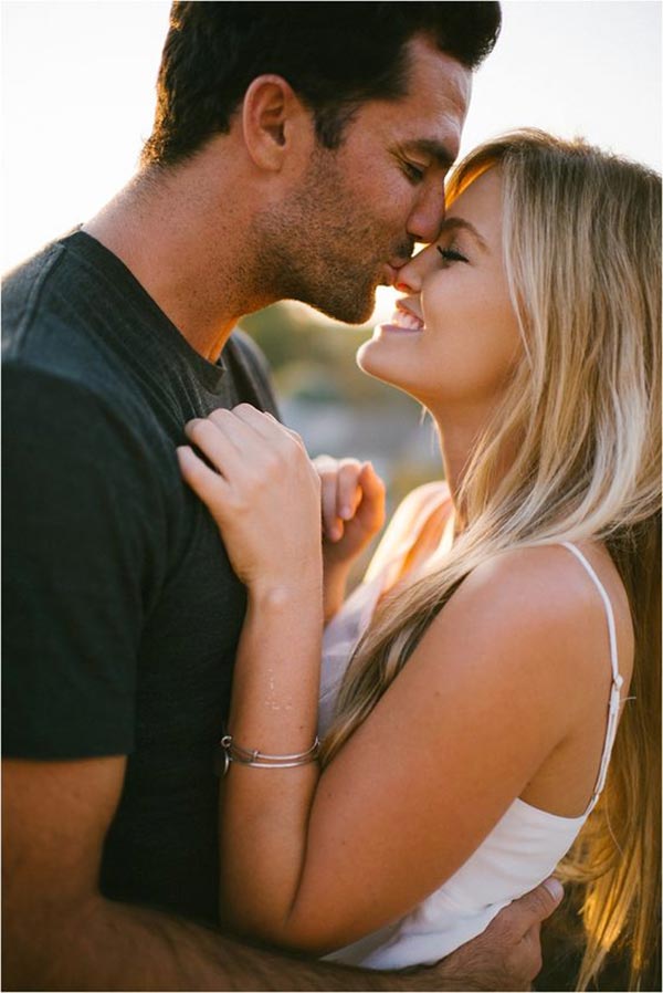 A kiss on her forehead couple poses