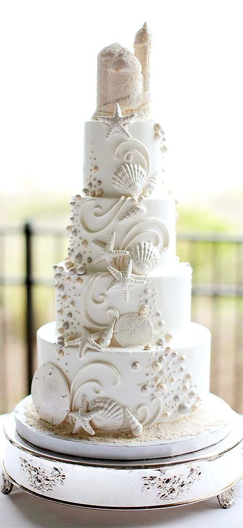 A royal multi layered beach theme wedding cake