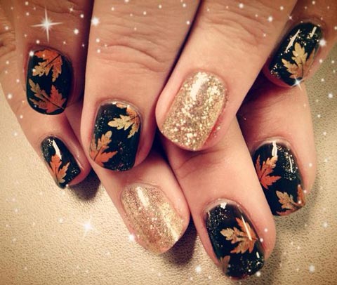 Black nails with maple leaves and giltter accents
