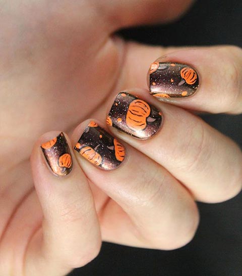 Dark brown nails with pumpkins and polka dots