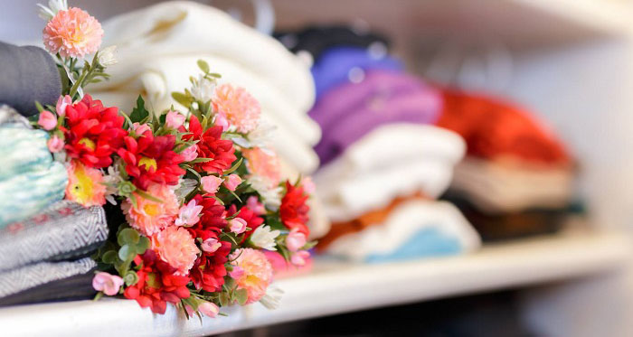 Flower bouquet on clothing shelf