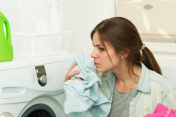 Beautiful girl doing laundry with good smelling laundry detergent