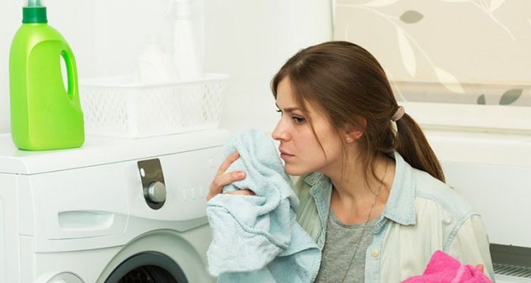 Beautiful girl doing laundry with good smelling laundry detergent