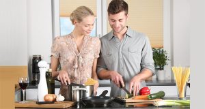 Husband and wife making food together in a healthier kitchen