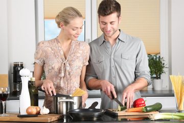 Husband and wife making food together in a healthier kitchen