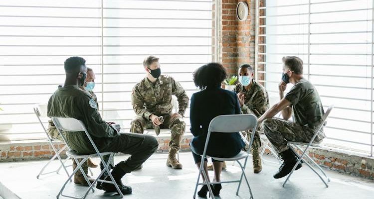 Group discussing PTSD coping strategies in a supportive conversation.