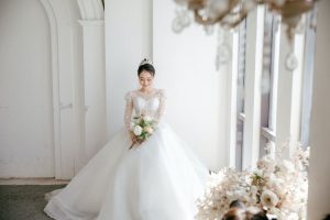 Radiant bride in a stunning white wedding gown, embodying timeless beauty.