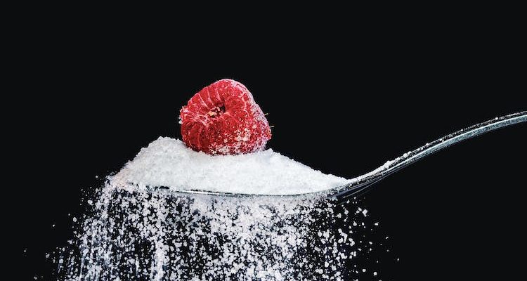 A spoon of raspberry and sugar used as a metaphor for type 1 diabetes.