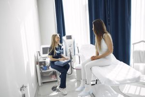 Image of a nurse engaged in conversation with a female patient.