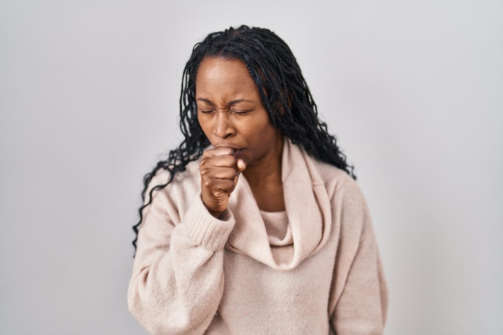 A female figure with a hand covering her mouth, indicating coughing or illness.