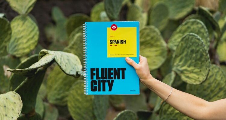 AP Spanish tutor holding Fluent City Spanish book, aiding student's language proficiency.