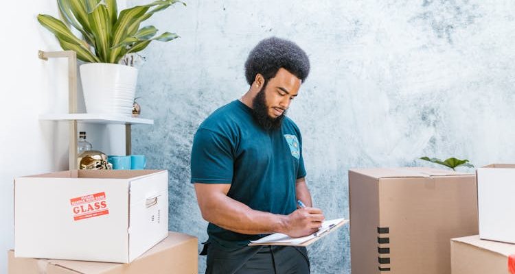 A man inspecting mobile storage boxes for organization and functionality.