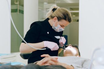 A dentist examining a patient in a dentistry clinic.
