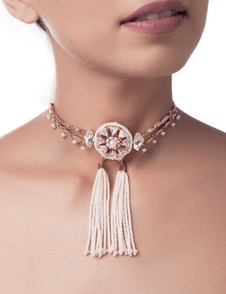 A woman adorned in an exquisite Indian-style choker, radiating regal elegance.